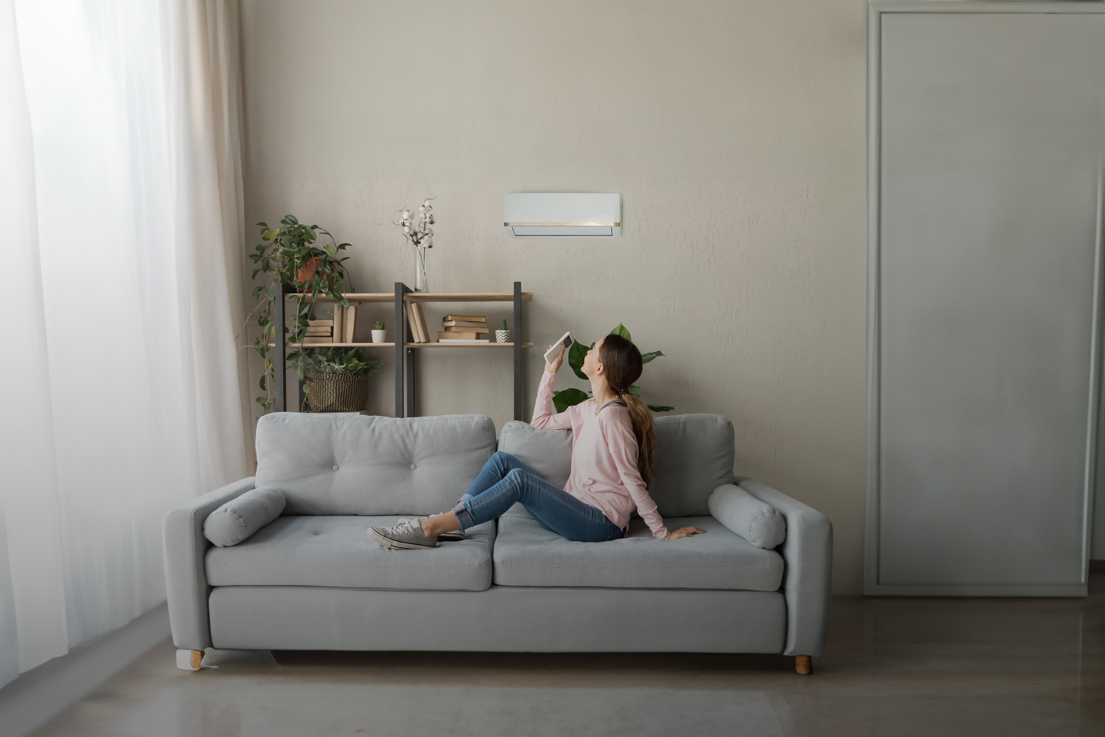 Happy woman holding cooler system remote controller enjoying fresh air
