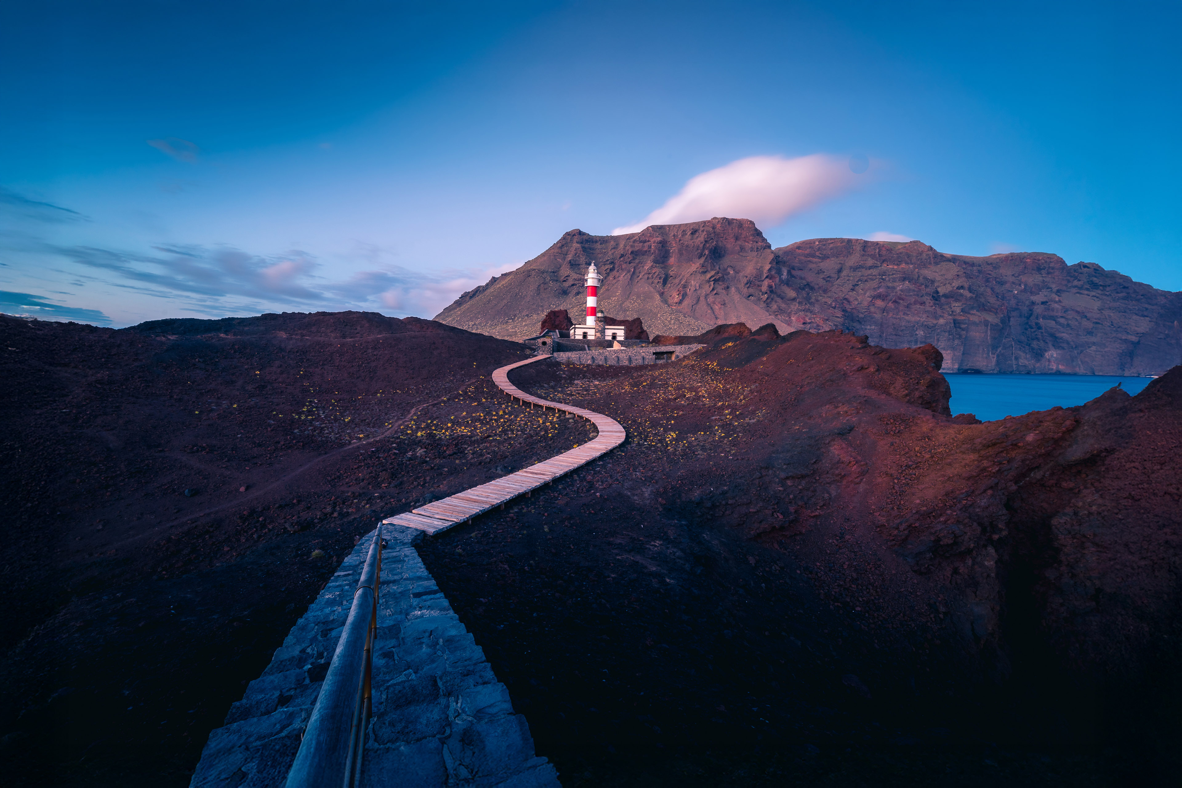 Pathway leading to lighthouse at dusk