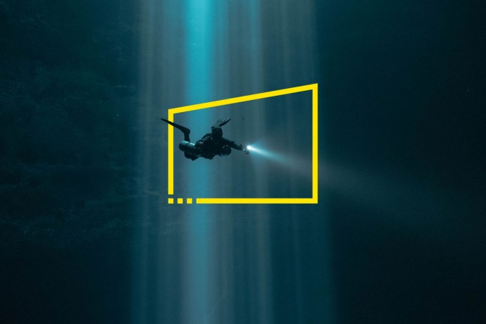 Scuba Diver in Light Beams in Mexico Cenote