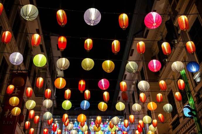 Low angle view of illuminated lanterns hanging over street