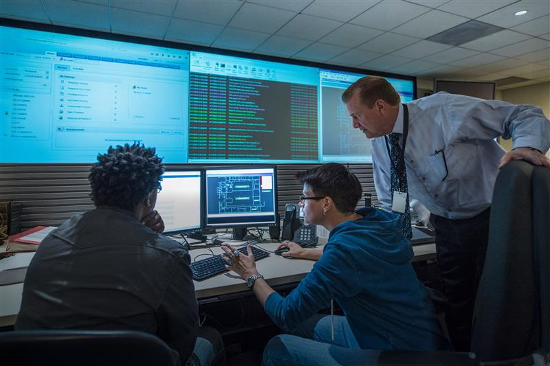 Colleagues Working Together In Server Control Room