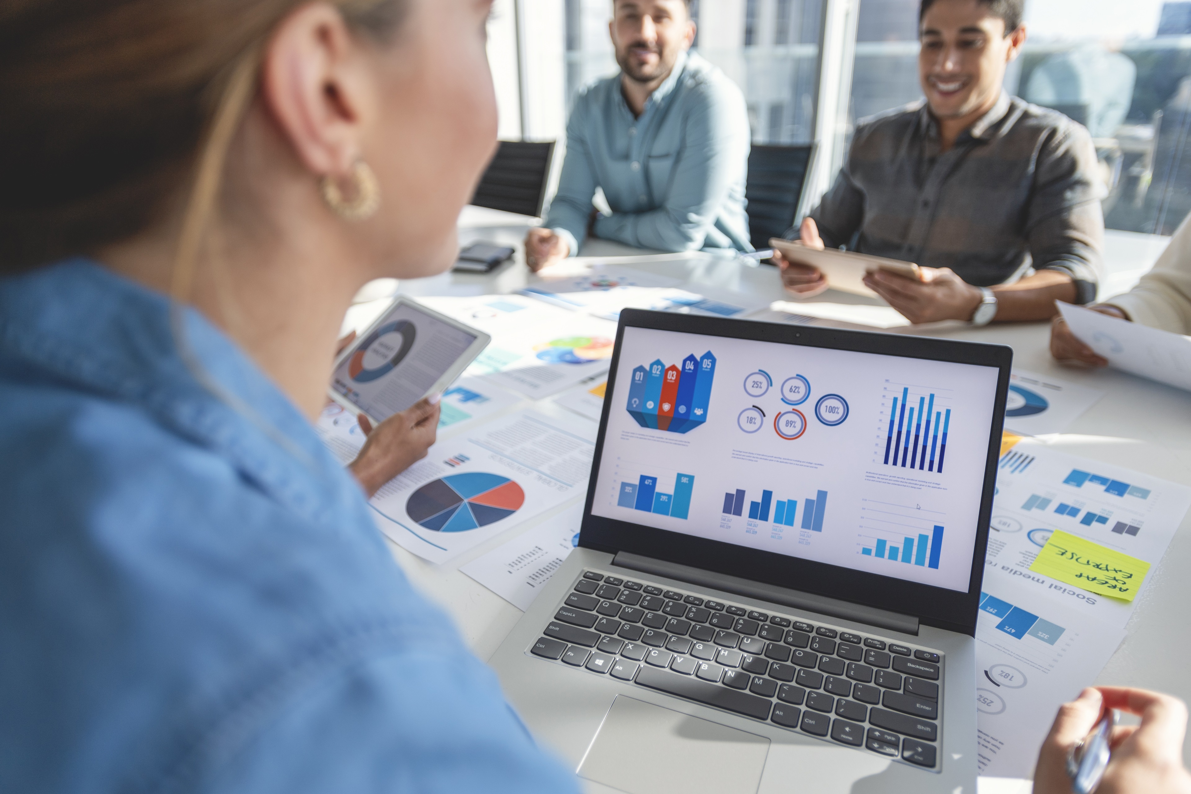 The documents have financial or marketing figures, graphs and charts on them.
