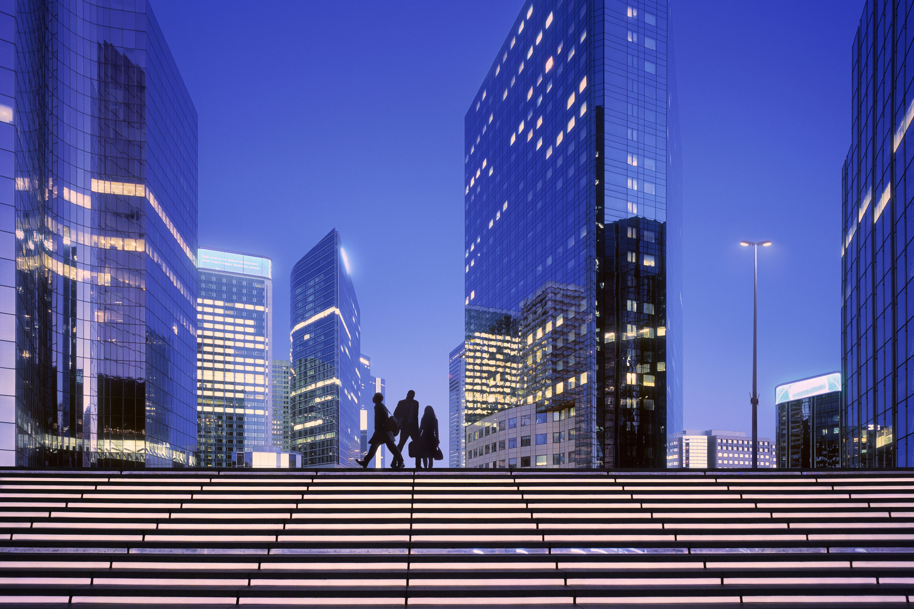 Early morning with business people arriving at modern business district