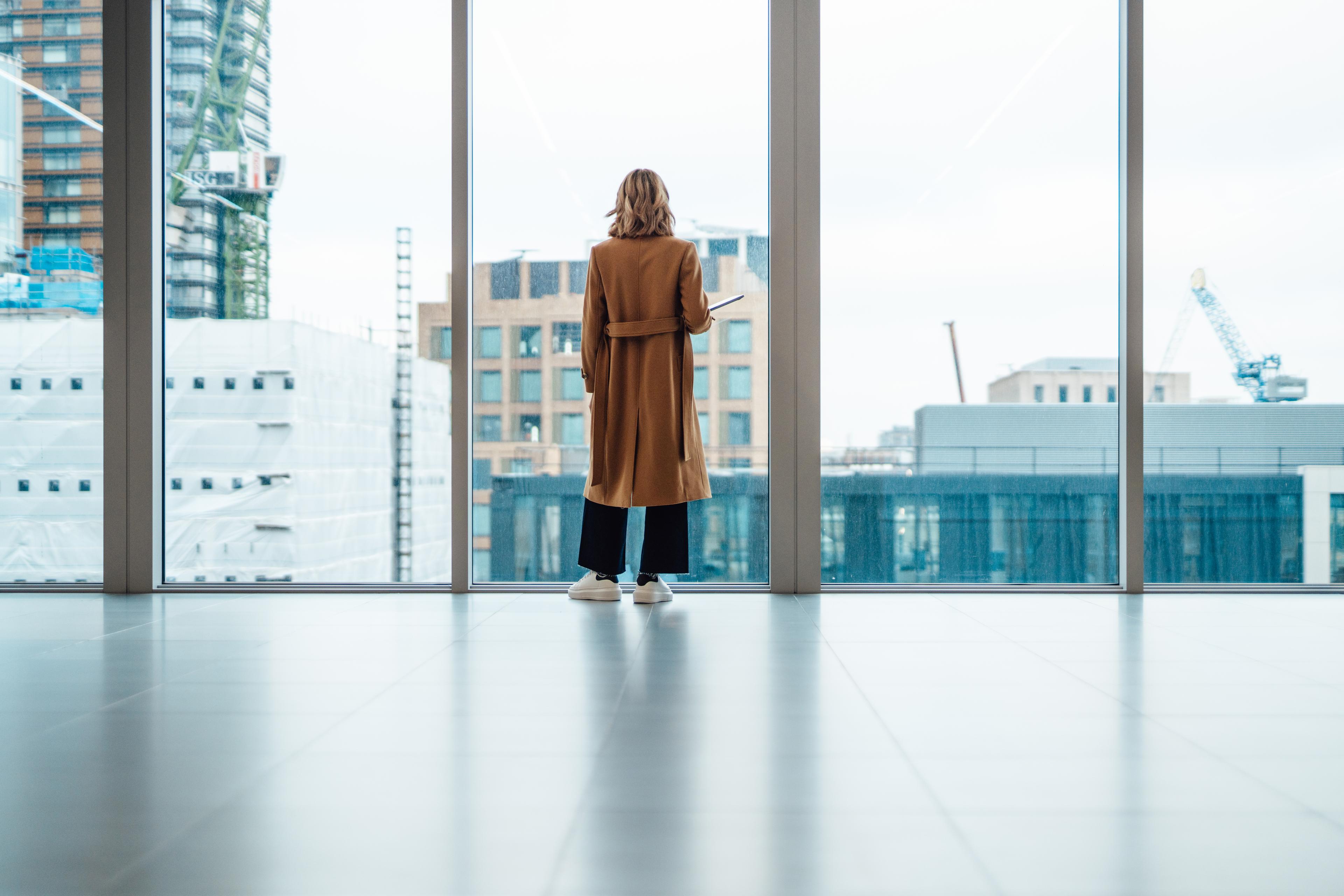 Businesswoman looking out window in meeting room