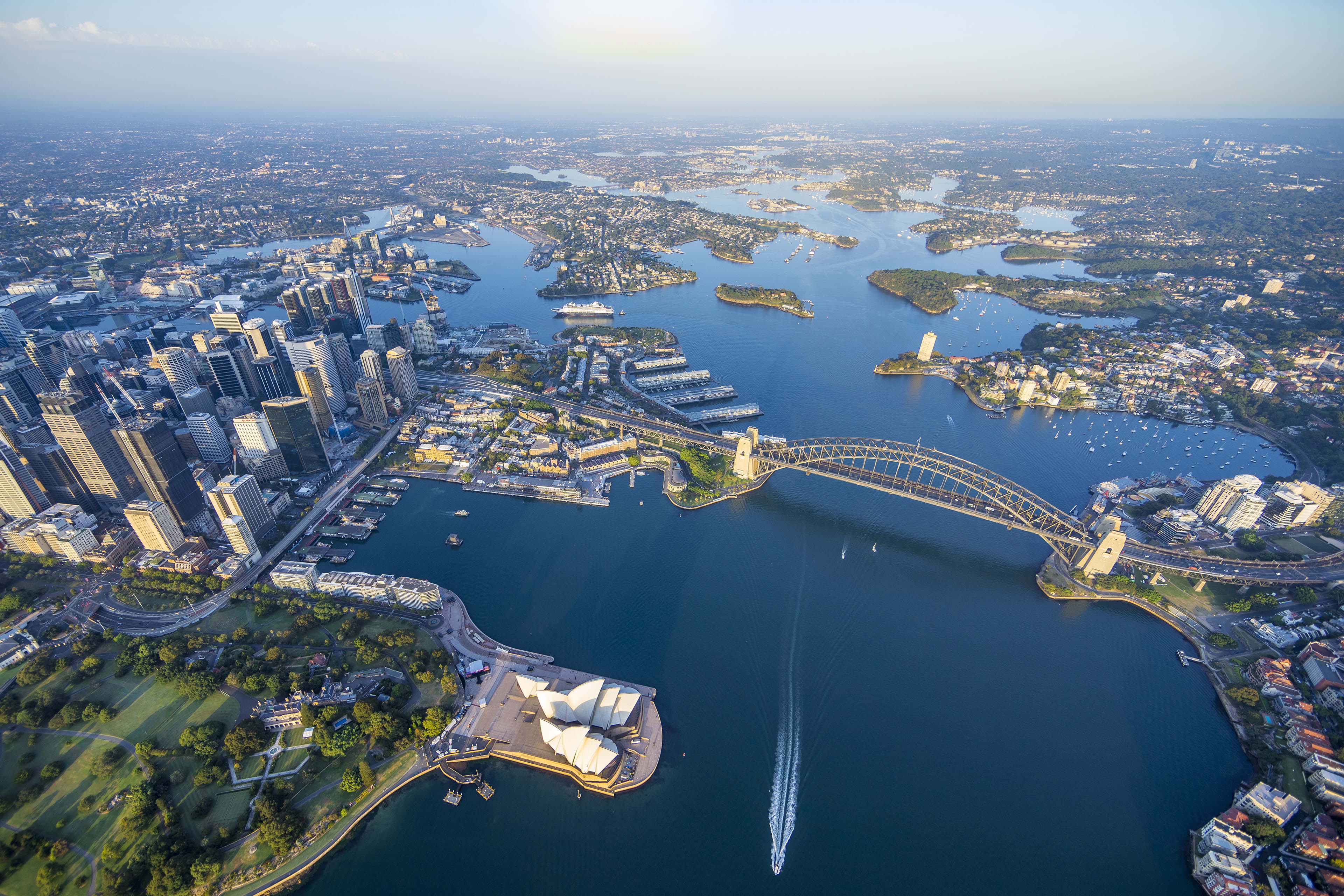 Aerial view of Sydney Harbour Bridge and Opera House along the waterfront