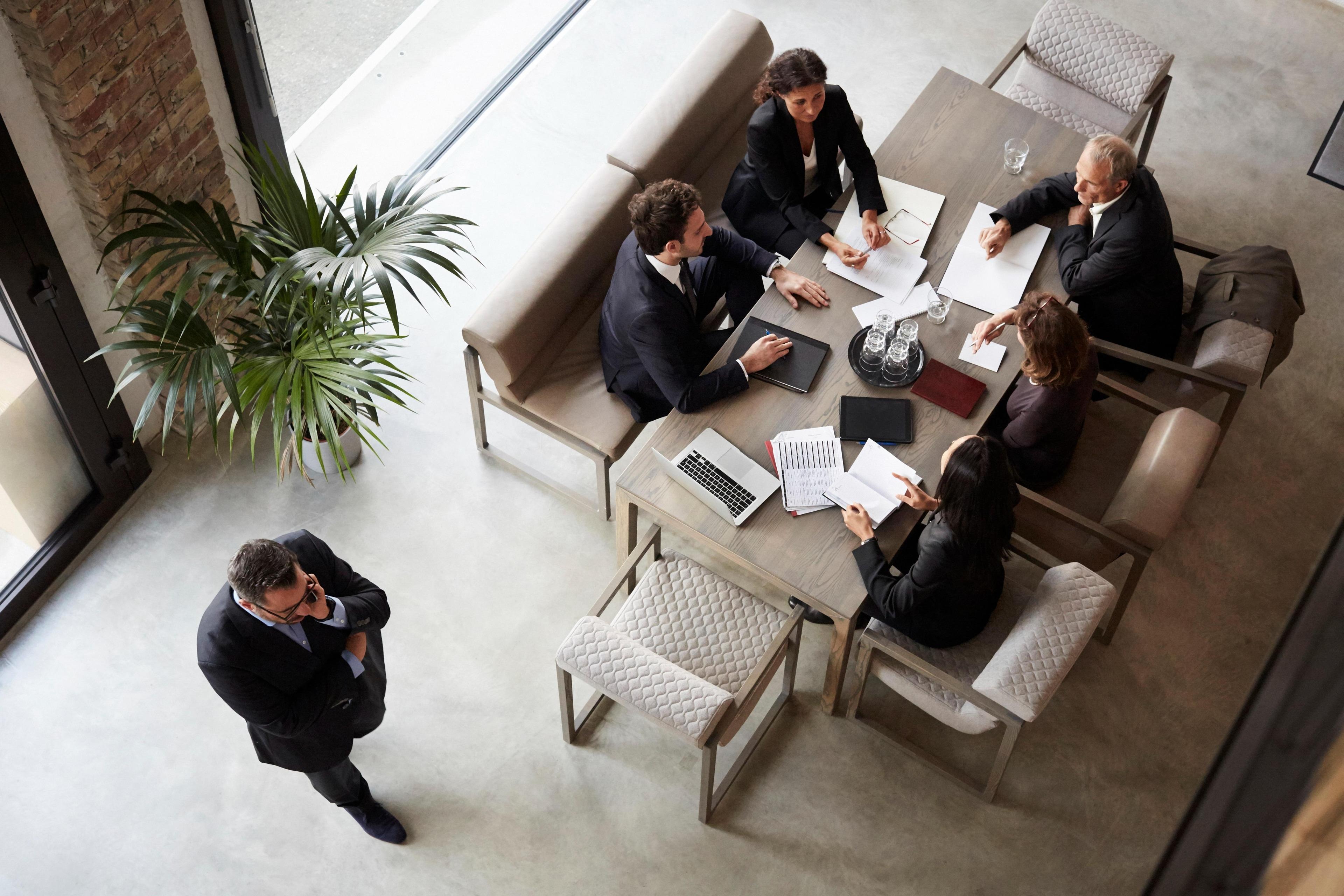 Financial advisors planning with business coworkers at a meeting