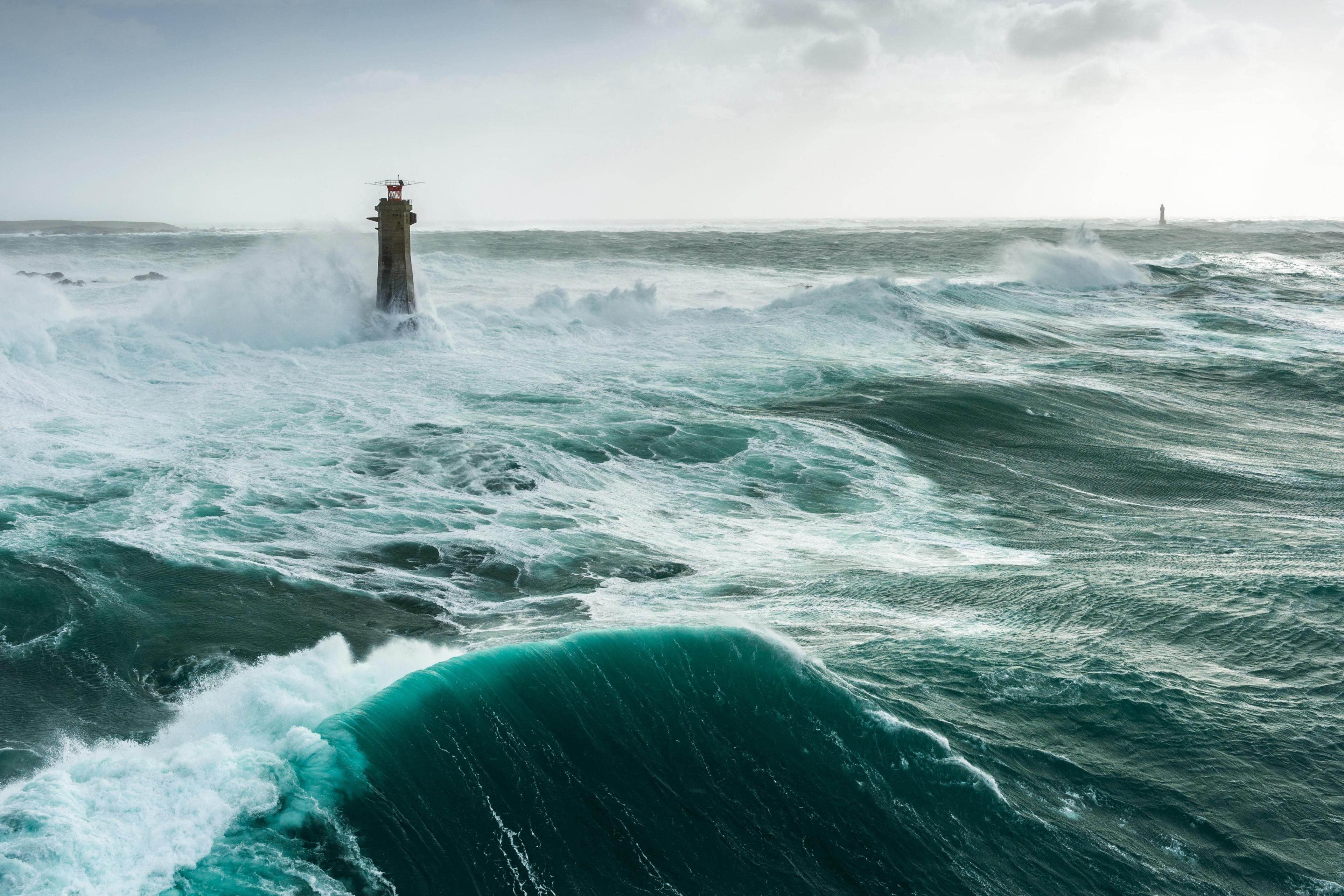 Lighthouse pounded by waves from a storm