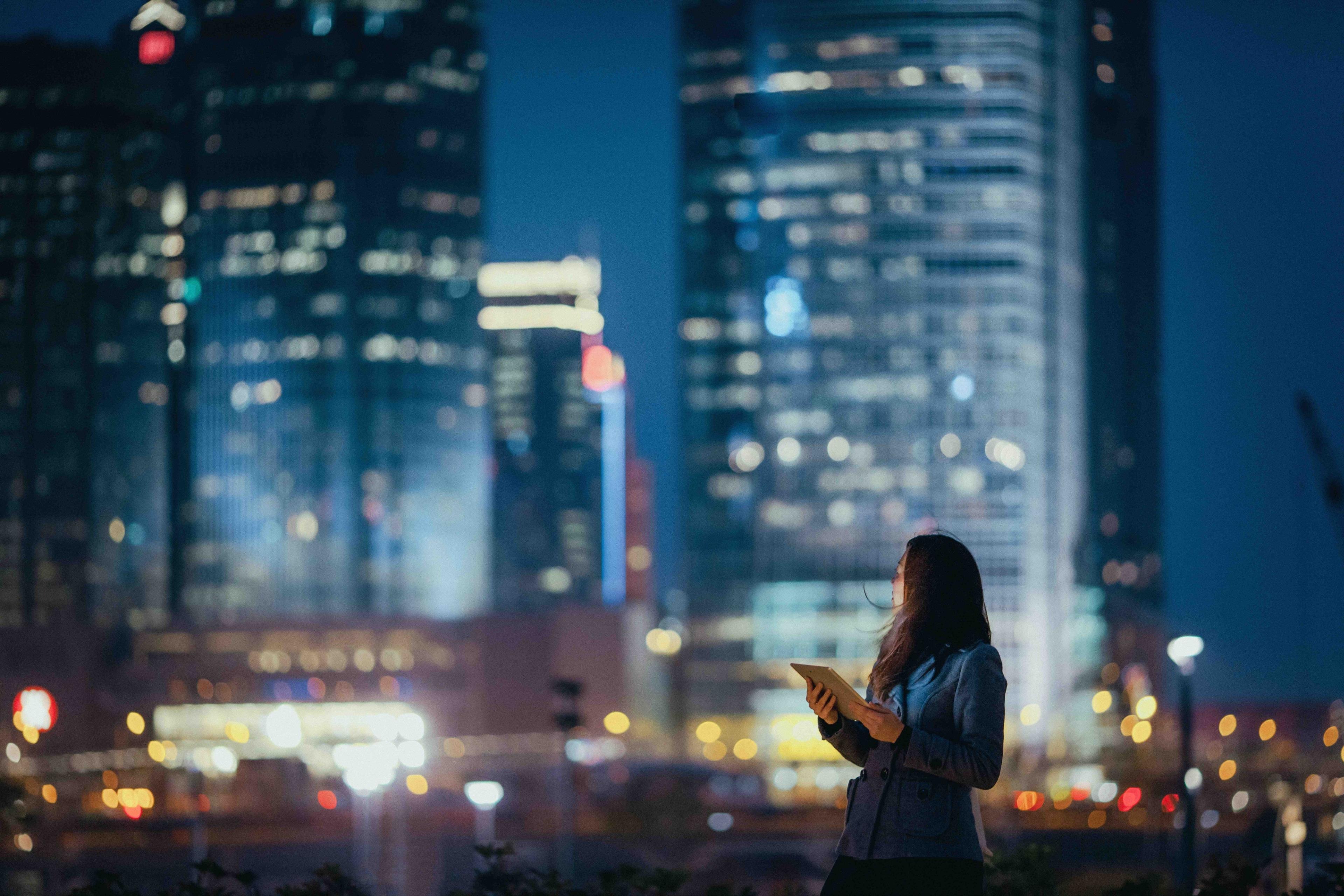 Young businesswoman using digital tablet in a city