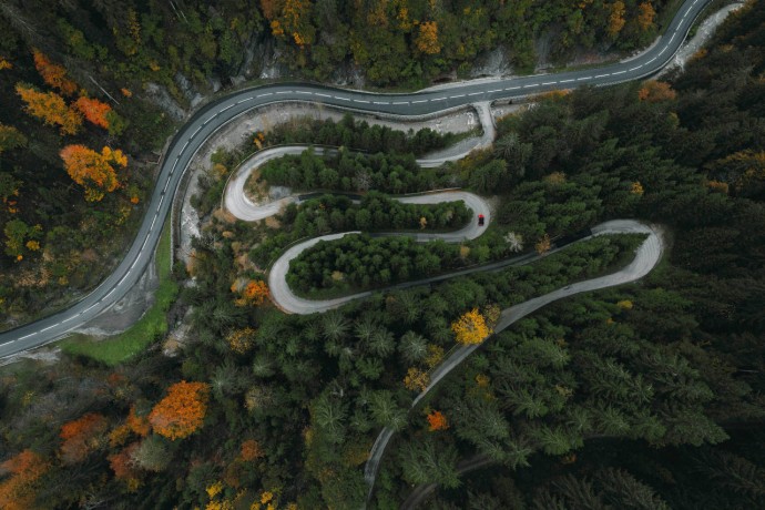 Winding road through forest in mountains