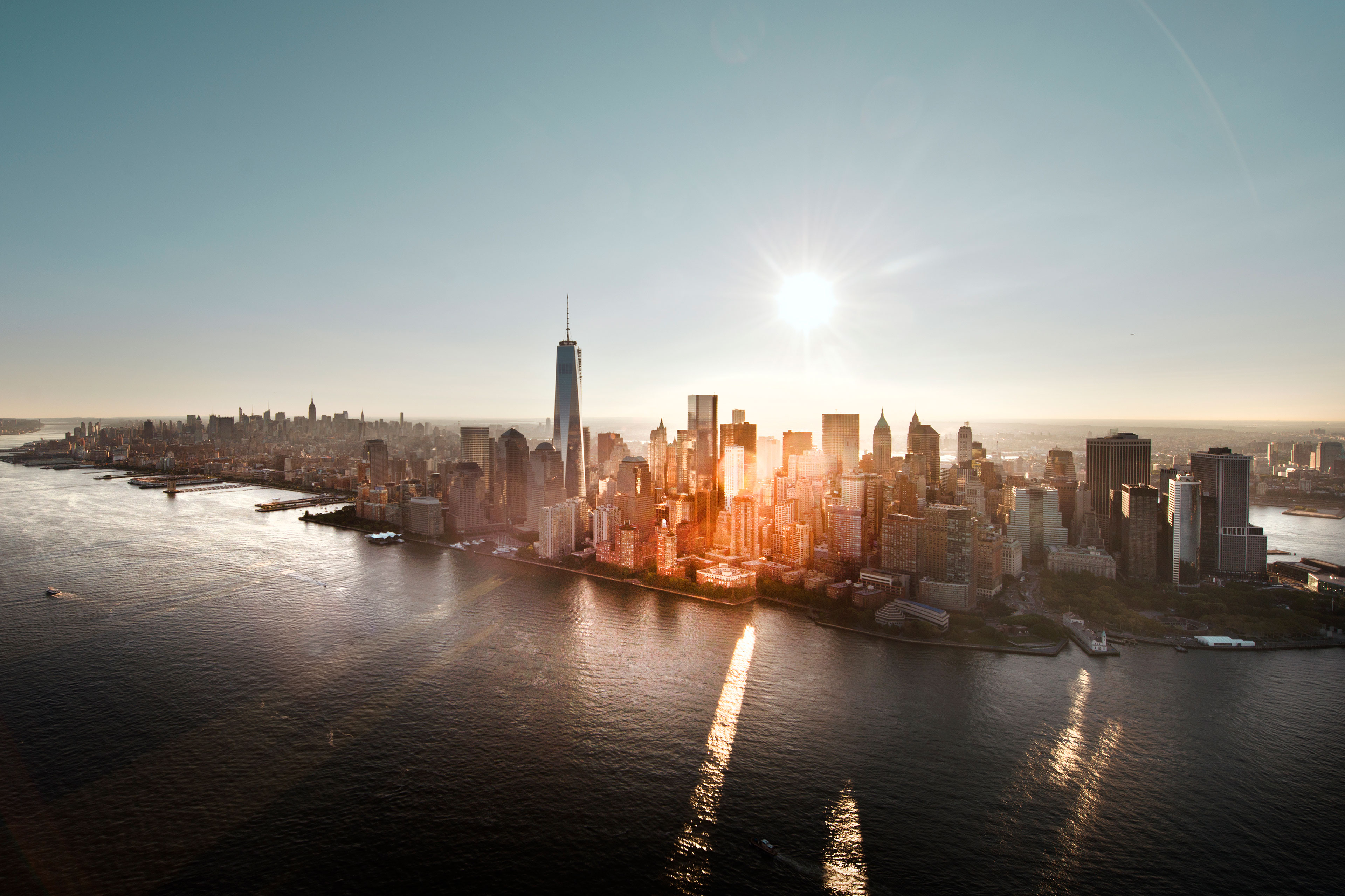 Realistic photo of a city by the river with bridges and waterfront promenades, Landscape Drone view