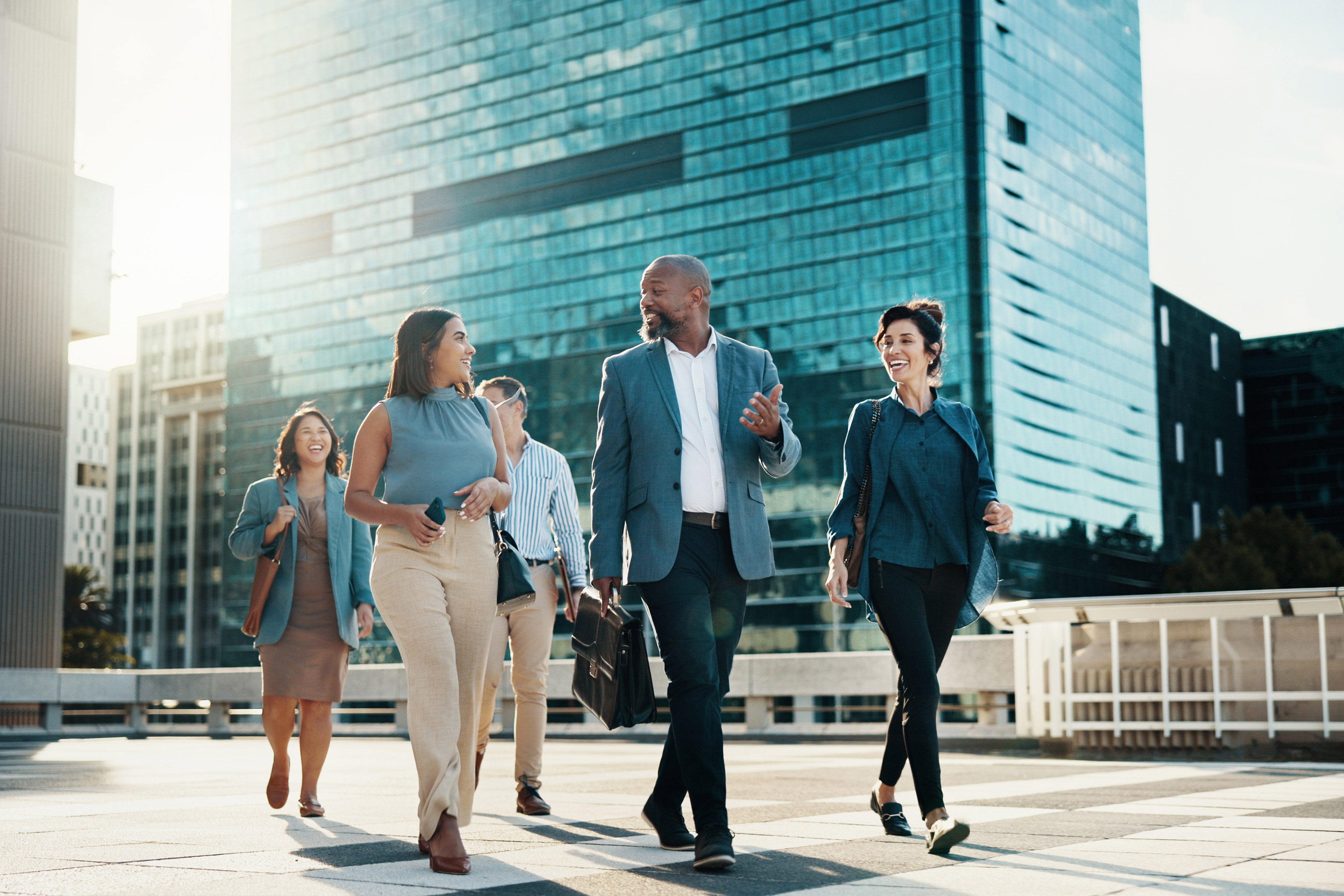 Business team walking in the city, discussing collaboration and partnership during their morning commute