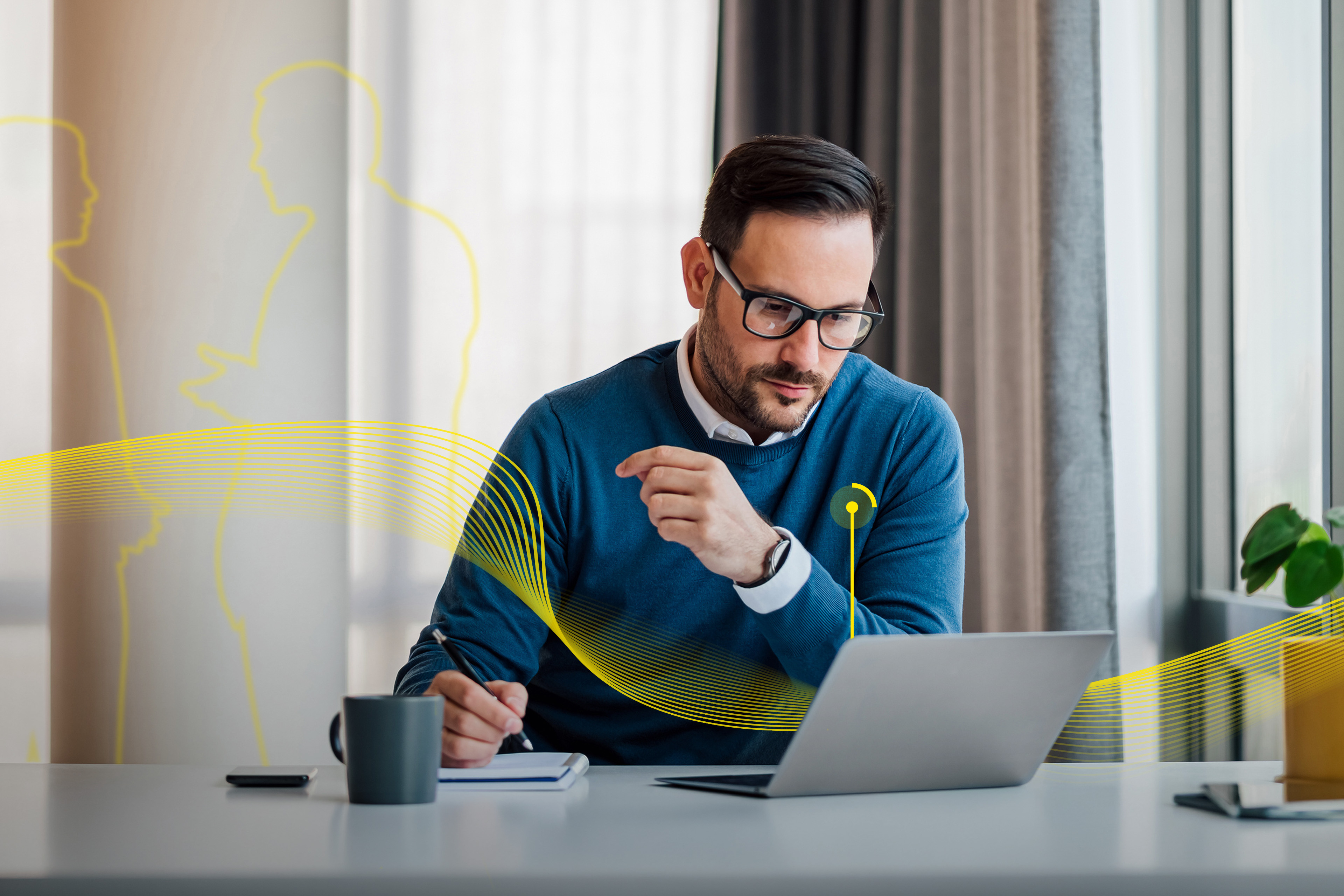 Professional using a laptop and taking notes at a desk in a modern office with abstract yellow graphics.