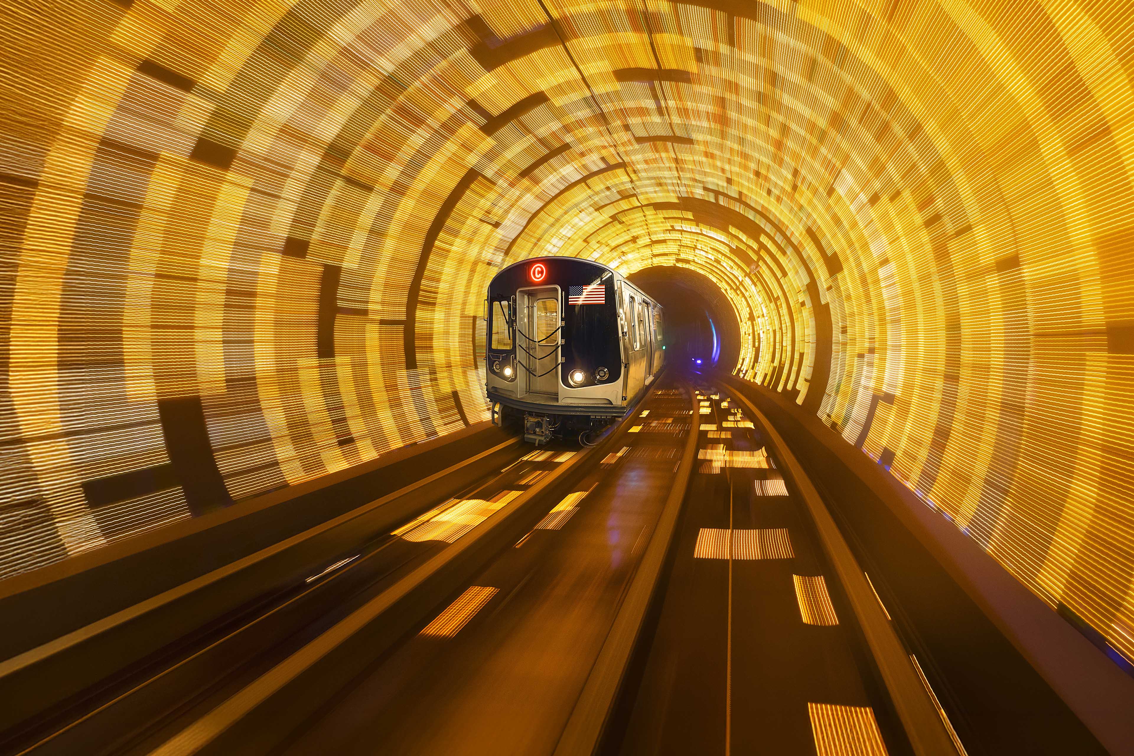 Speeding C Eighth Avenue subway train on tracks in New York City, USA.