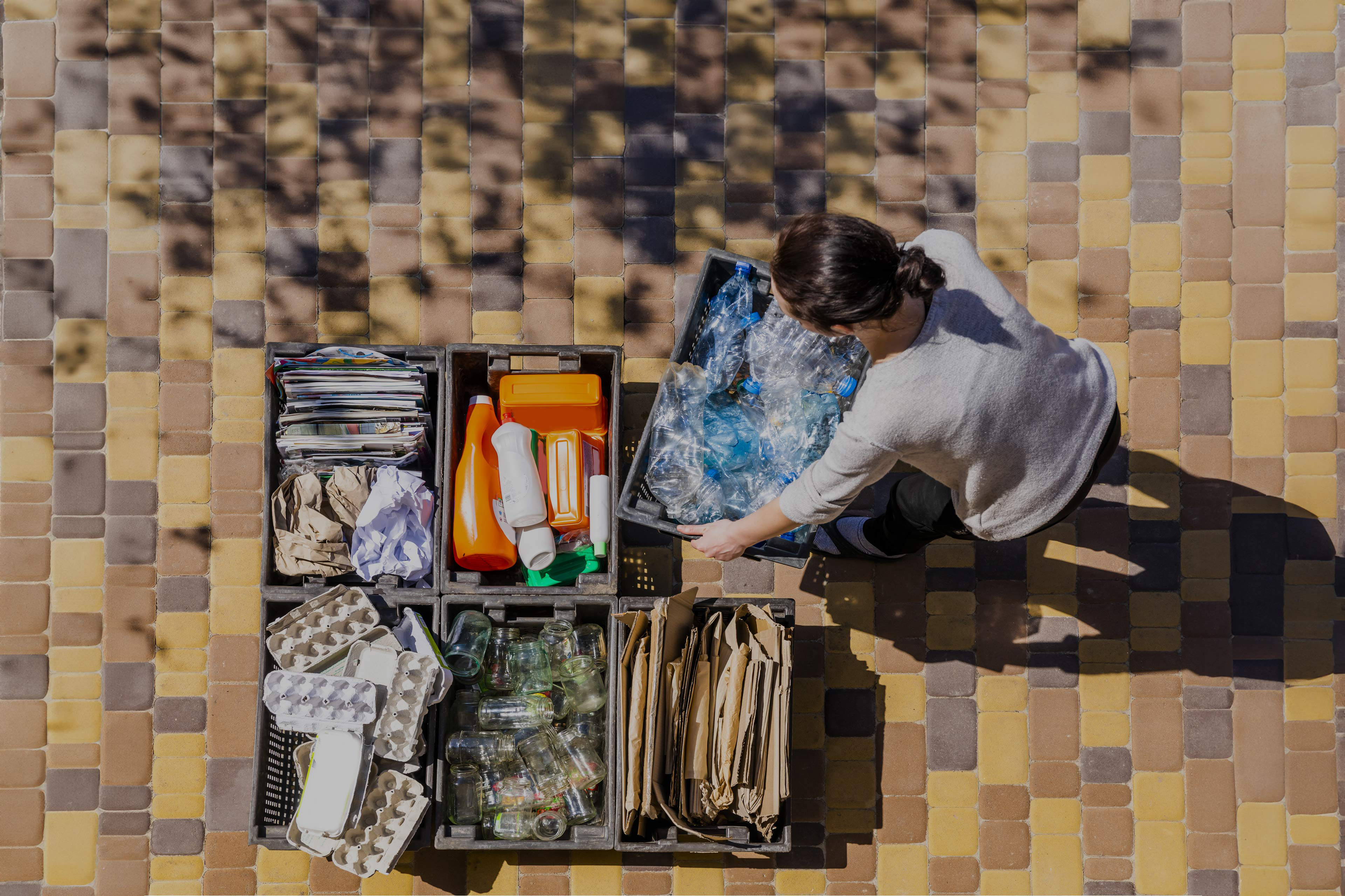 Woman organizes trash containers for recycling