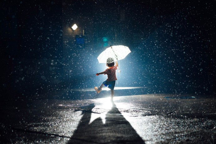 Baby Girl Holding Umbrella In Rain