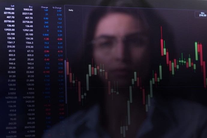 Female analyst viewing financial market data on a screen