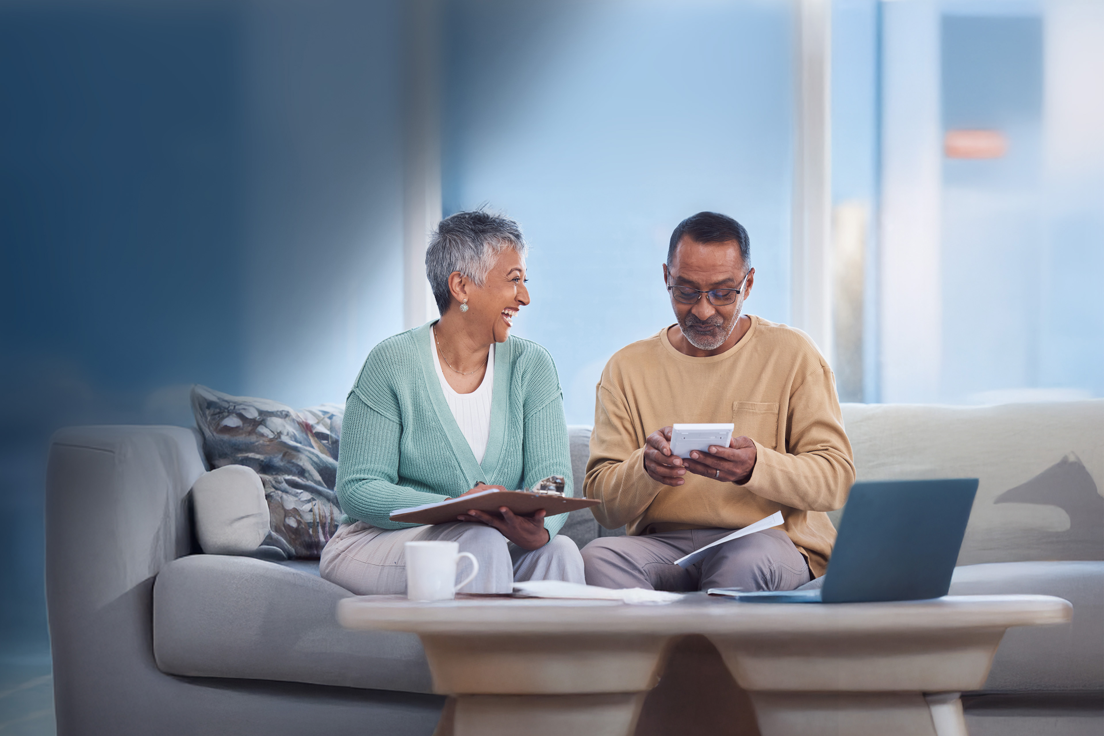 Budget, planning and senior couple on sofa paying debt, mortgage or bills together at home. 
