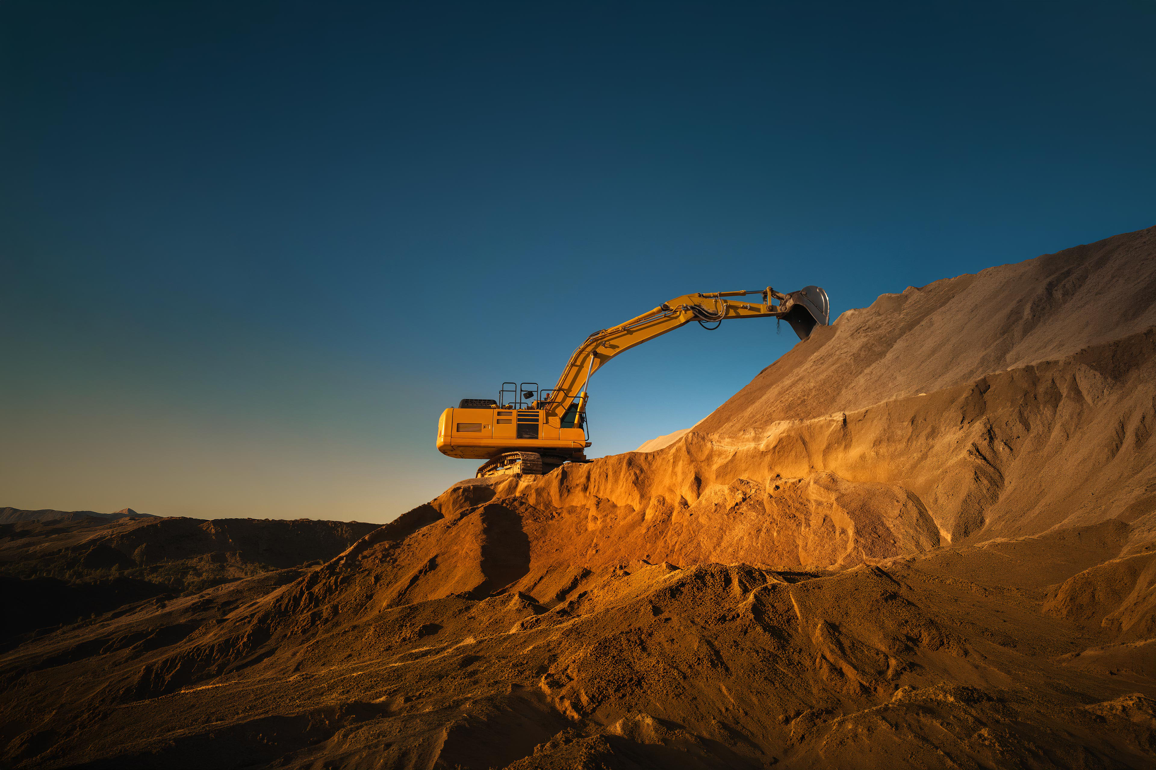 Industrial Excavator Digging Sand to Lay Foundation for Building New Apartment Complex.
