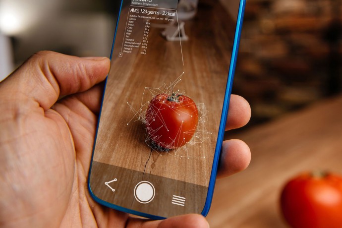 Men using artificial intelligence on smart phone with augmented reality application for recognizing food