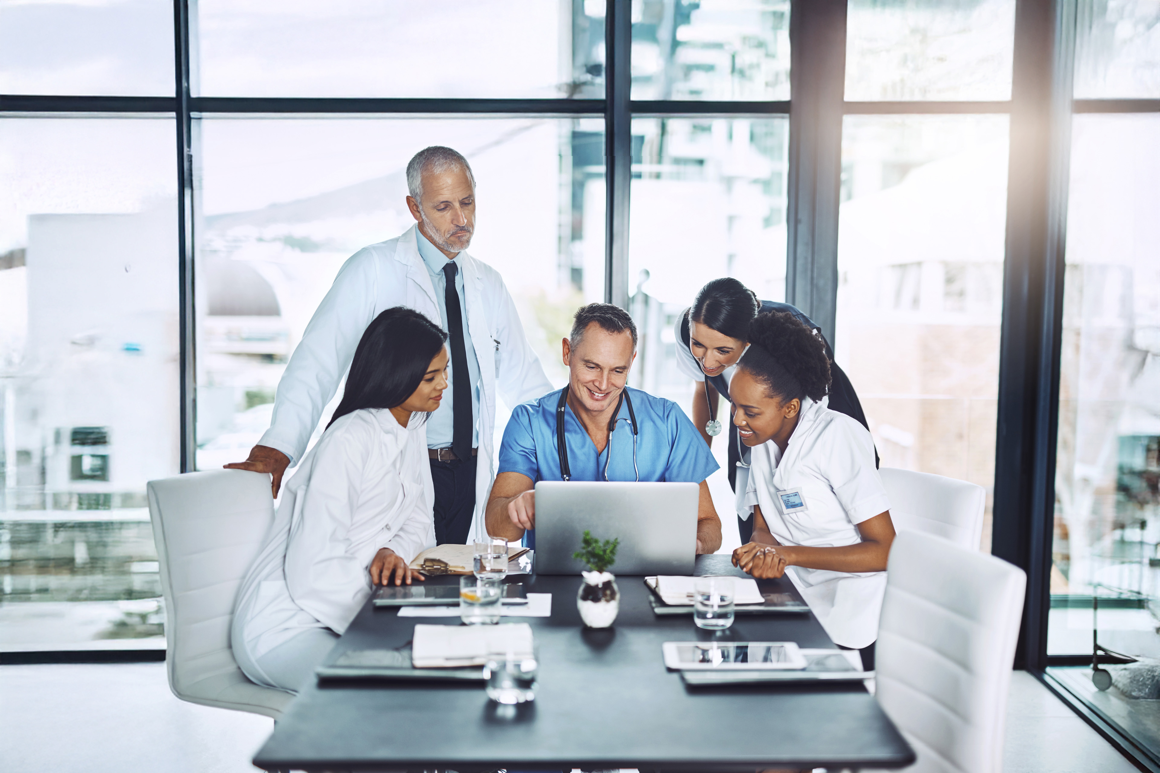 Man working on laptop while sitting in kitchen at home