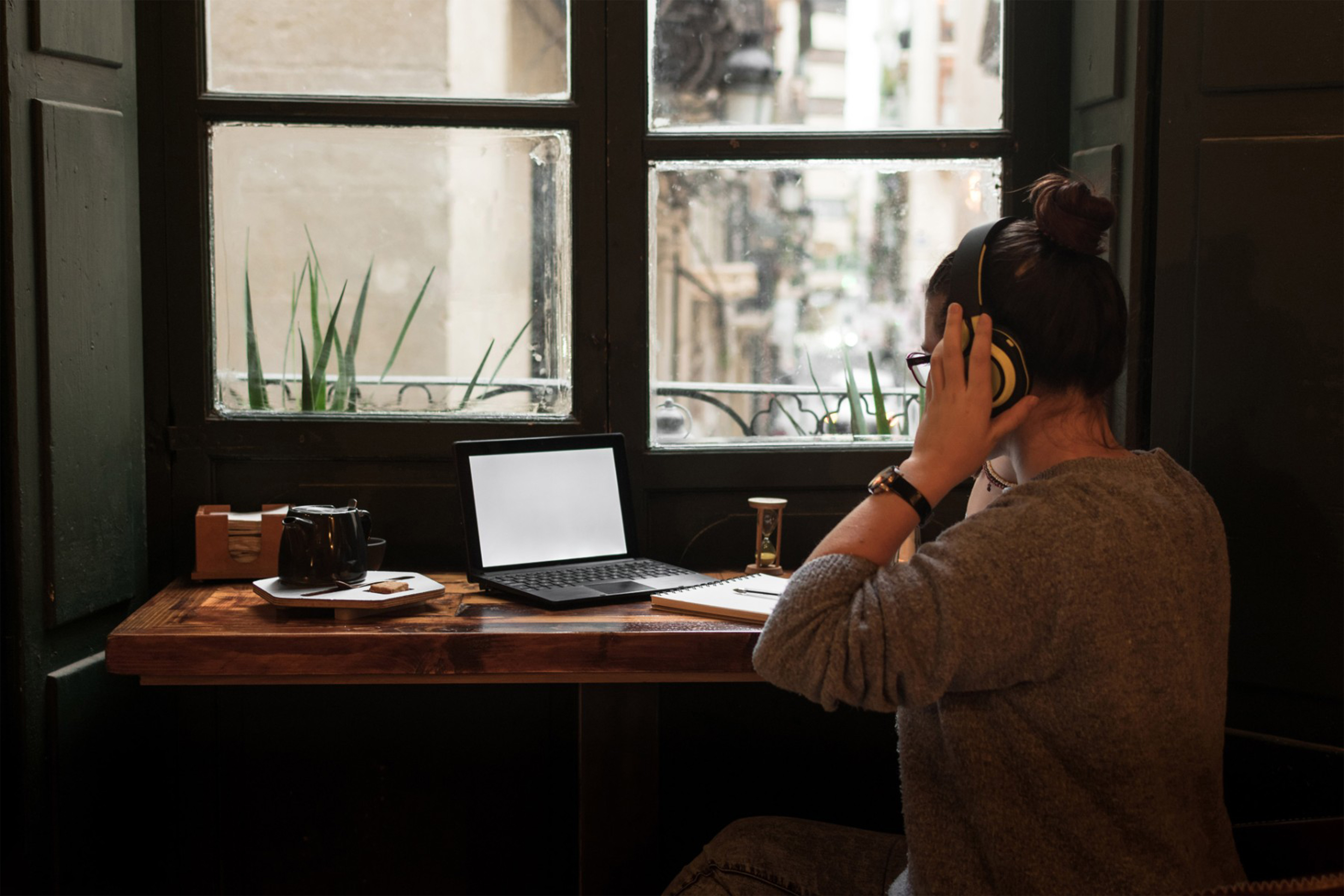 Young woman studies while she is listening music