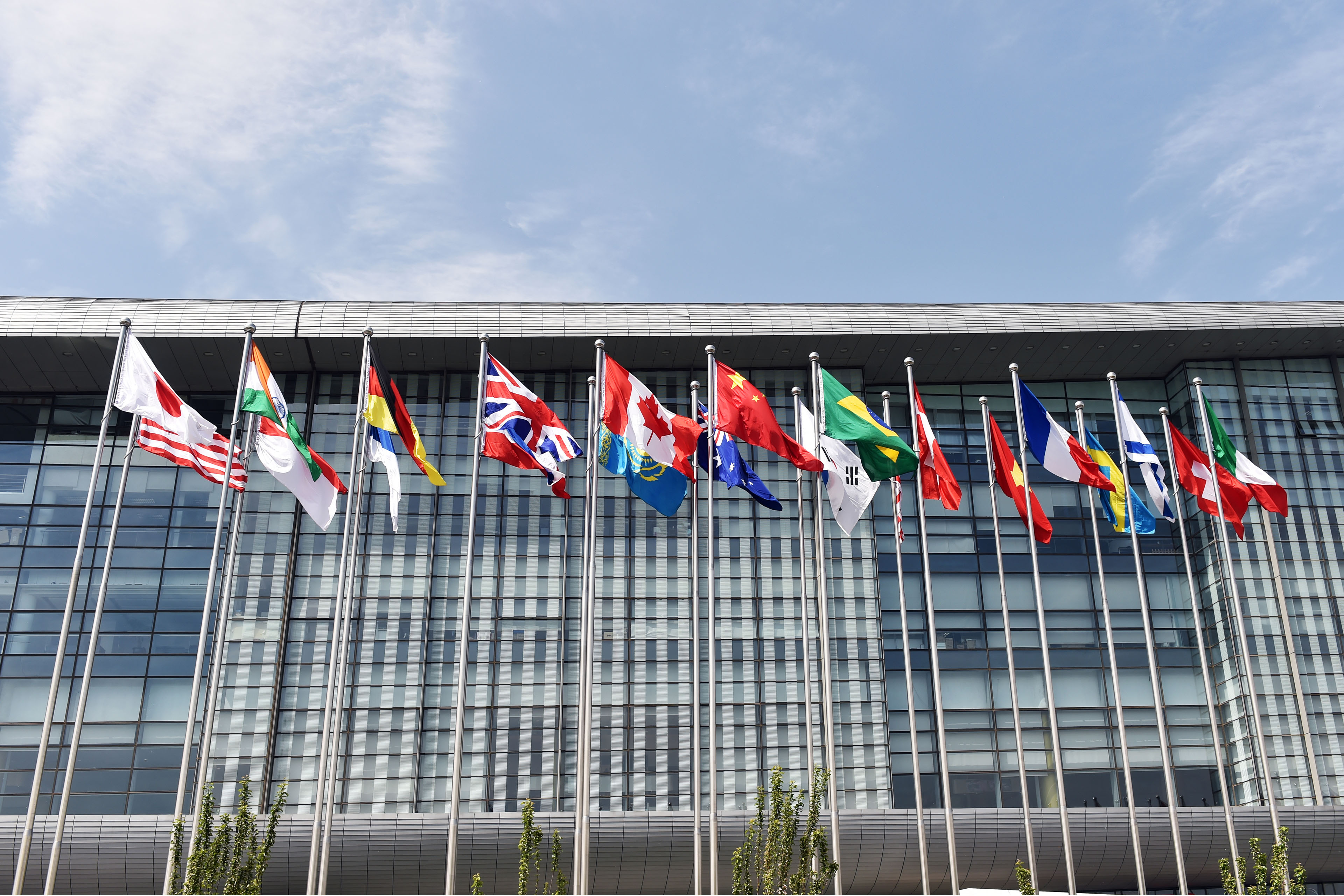National flags displayed outside a modern international office building