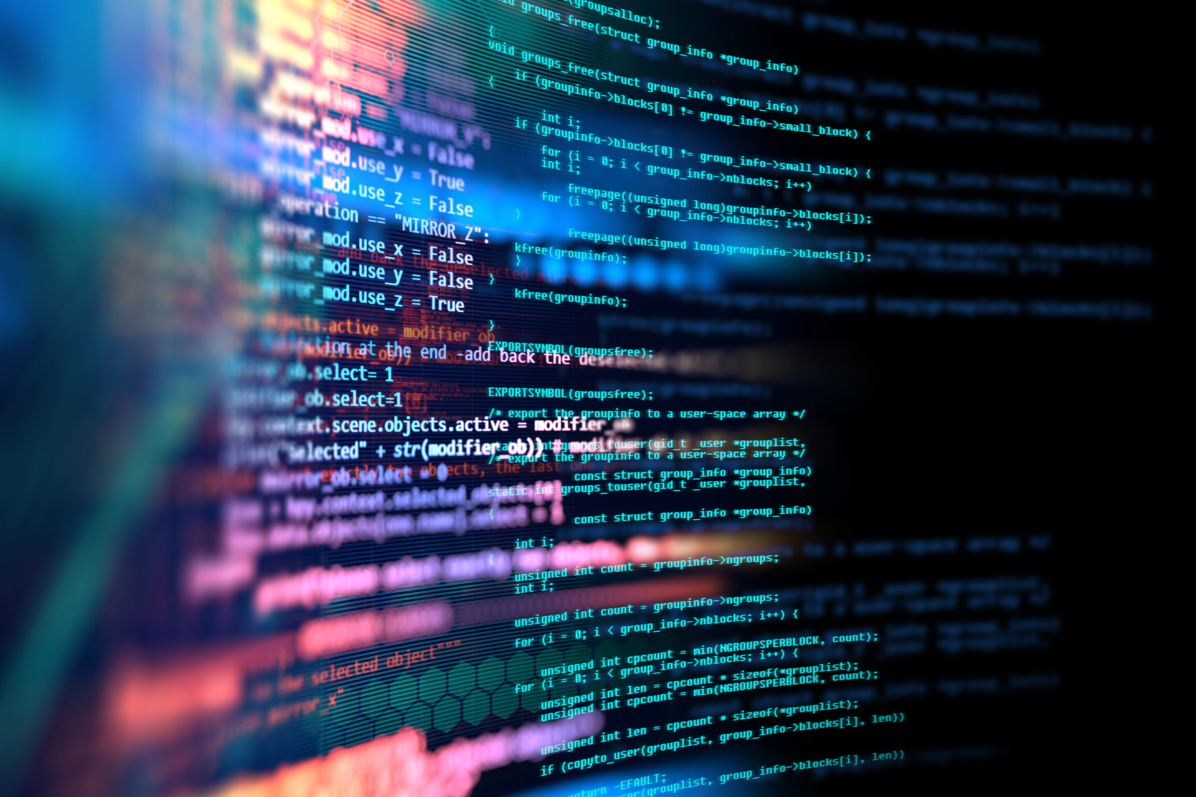 Close view of programming code on a screen with abstract light effects in the background