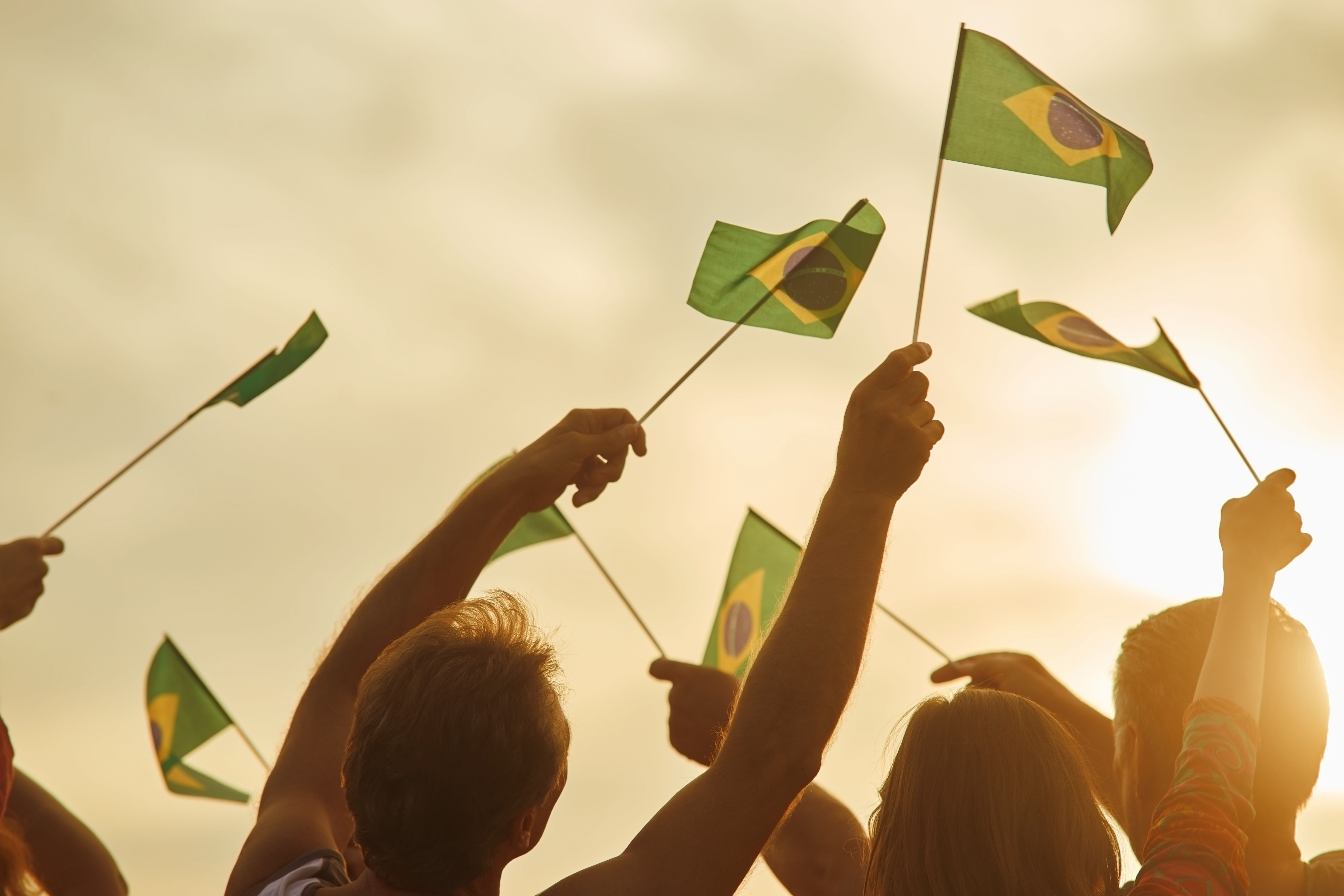 Människor som viftar med brasilianska flaggor