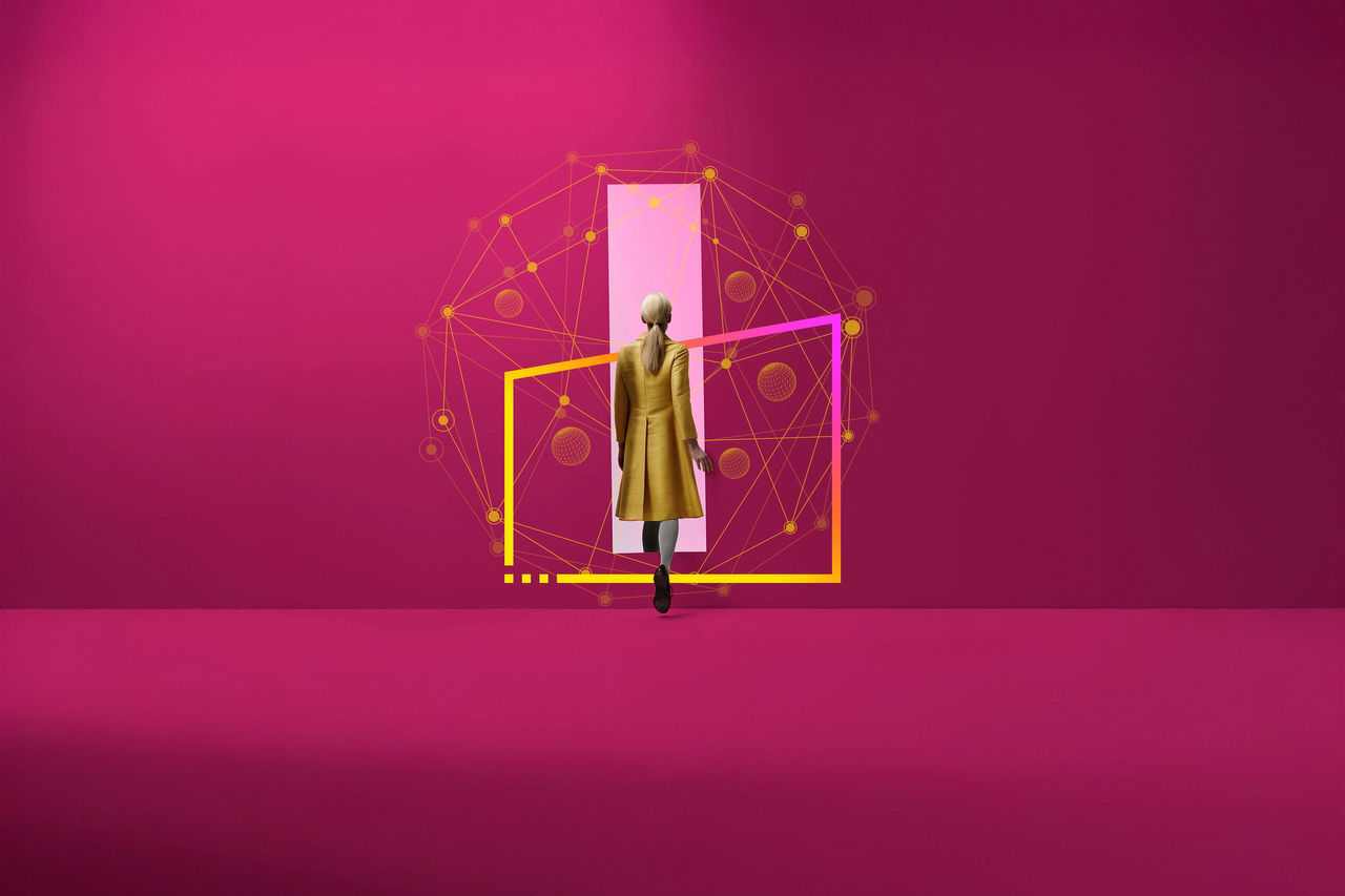 ey-woman-in-a-yellow-coat-walking-into-rectangular-opening-in-coloured-wall-frame-v2