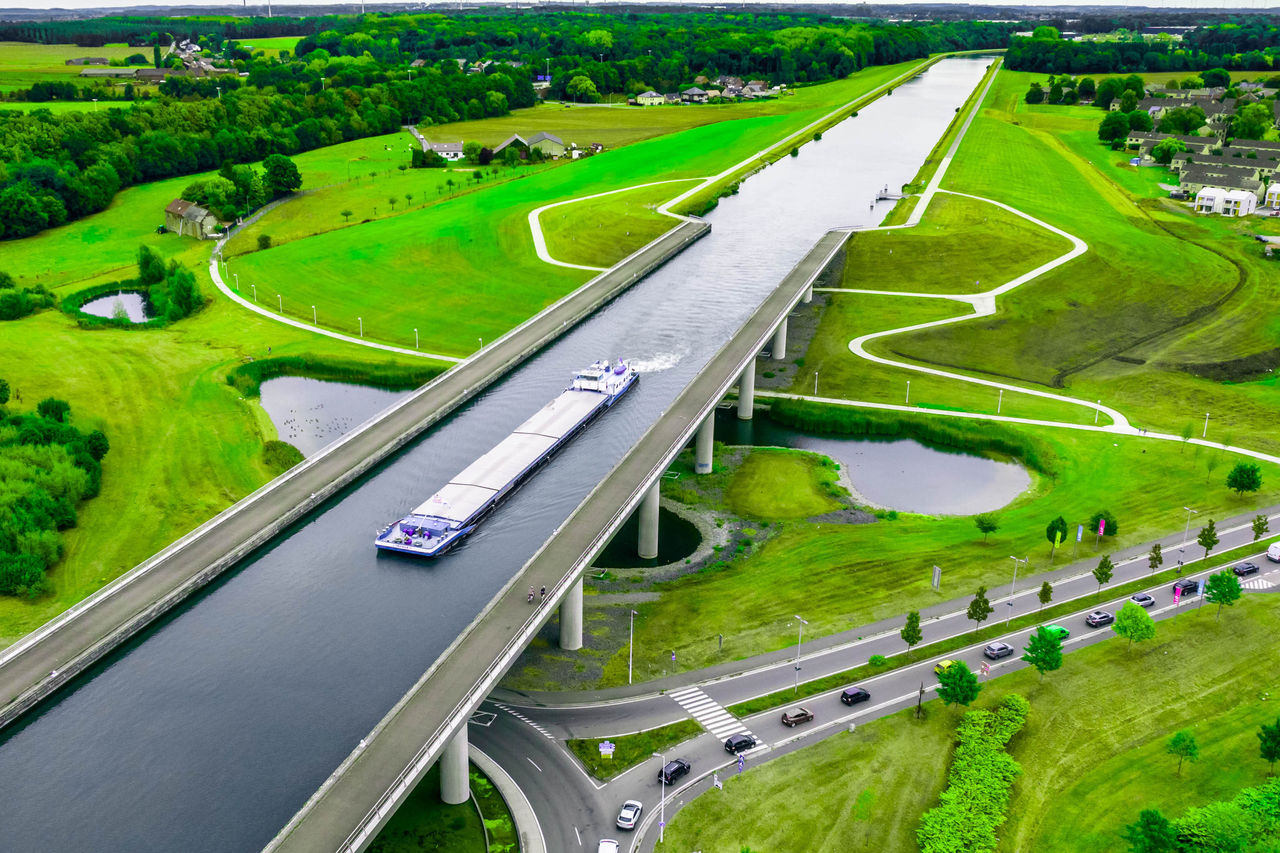 Aerial view of the Sart Canal bridge crossing a road in the green landscape of Belgium
