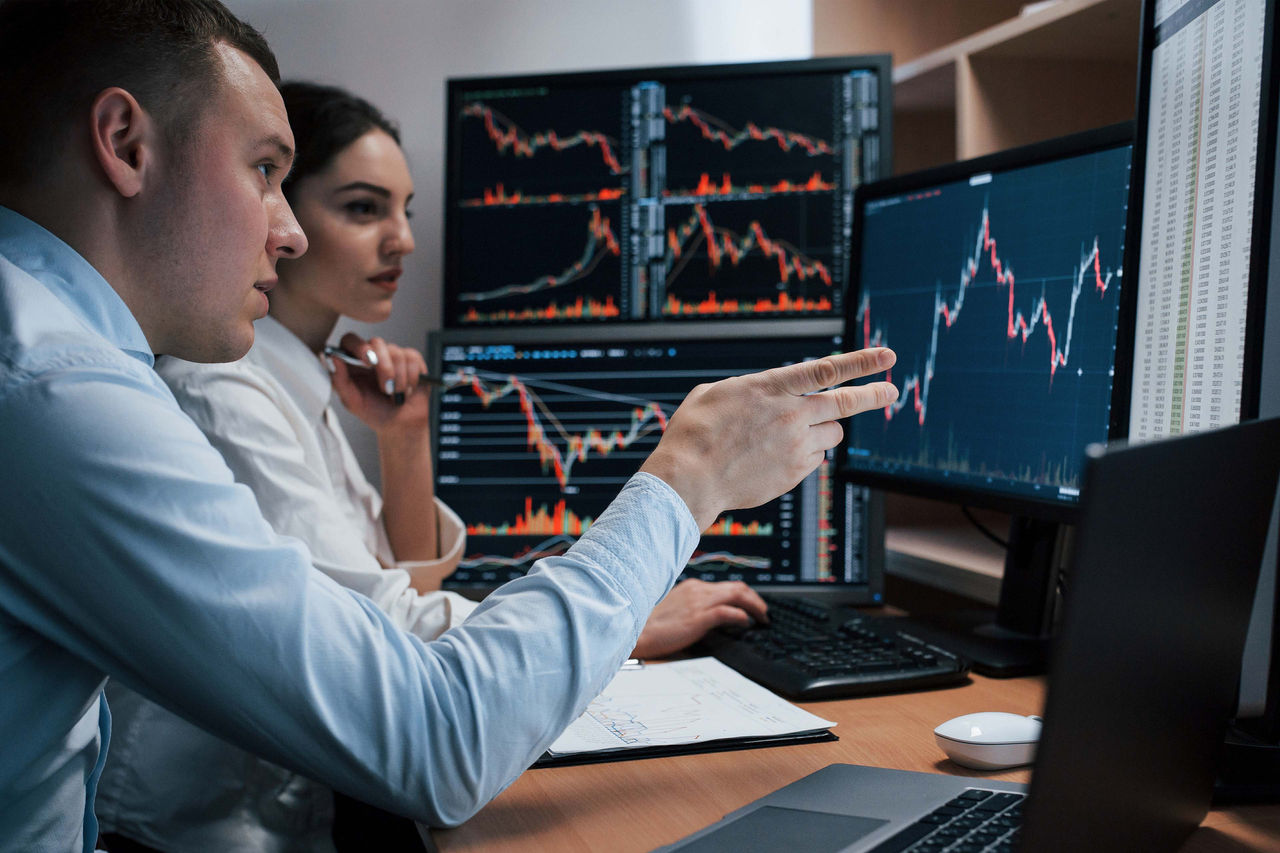 Christmas gift. Congratulations.Top wiew of woman holding traditional decorated gift box. Wooden table with cane,fir branches,fir cone, and berries