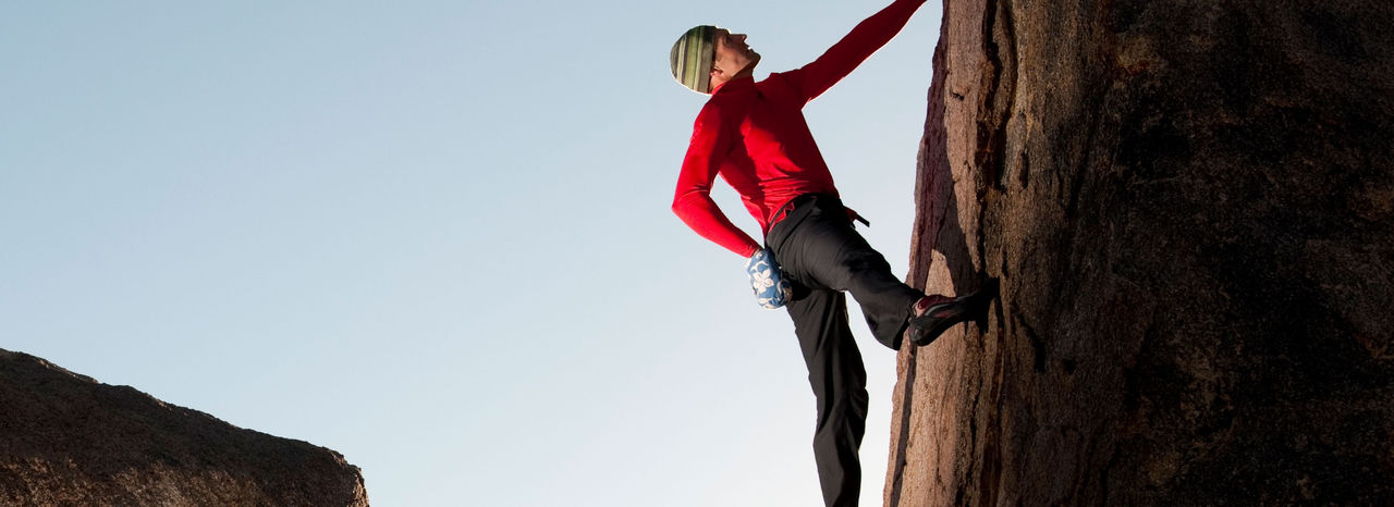 A man climbing on a rock