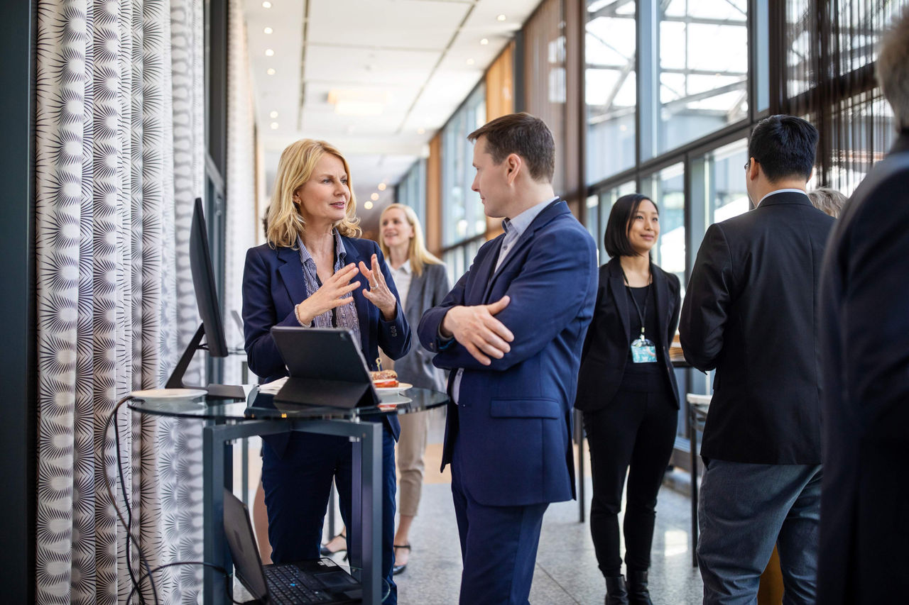 ey parthenon - ceo outlook survey - people in a conference lobby