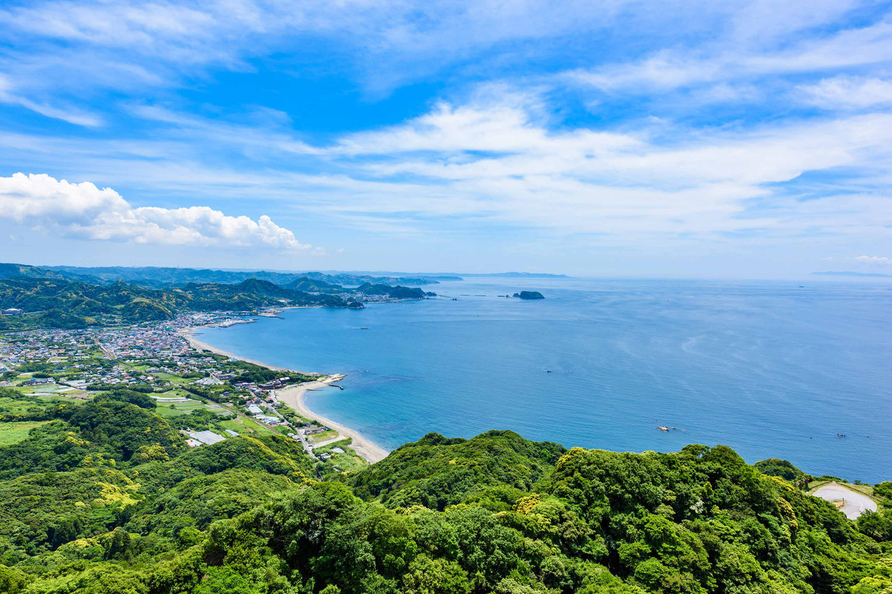 Aerial view of the illuminated cable-stayed bridge over the dark river