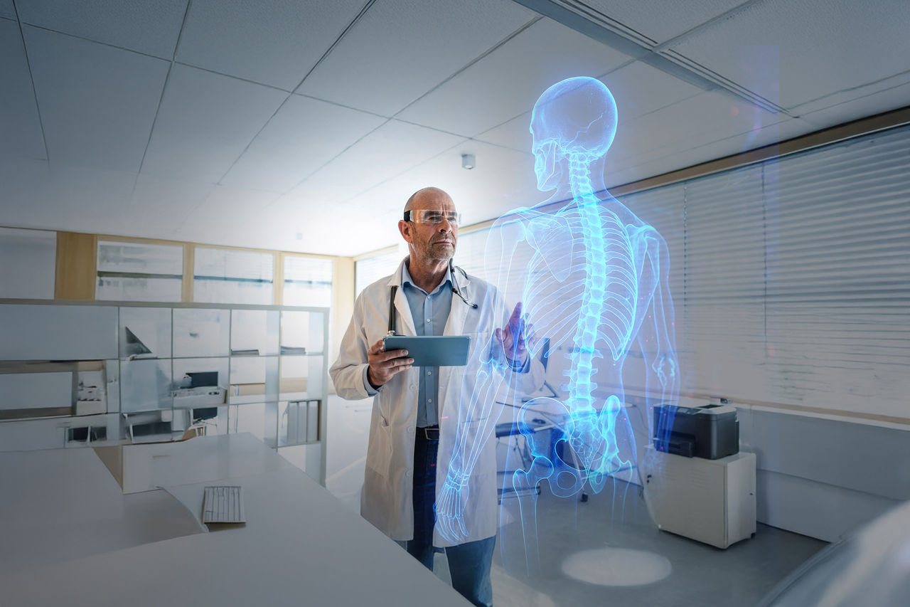 Doctor using AR glasses and tablet in a modern clinic office