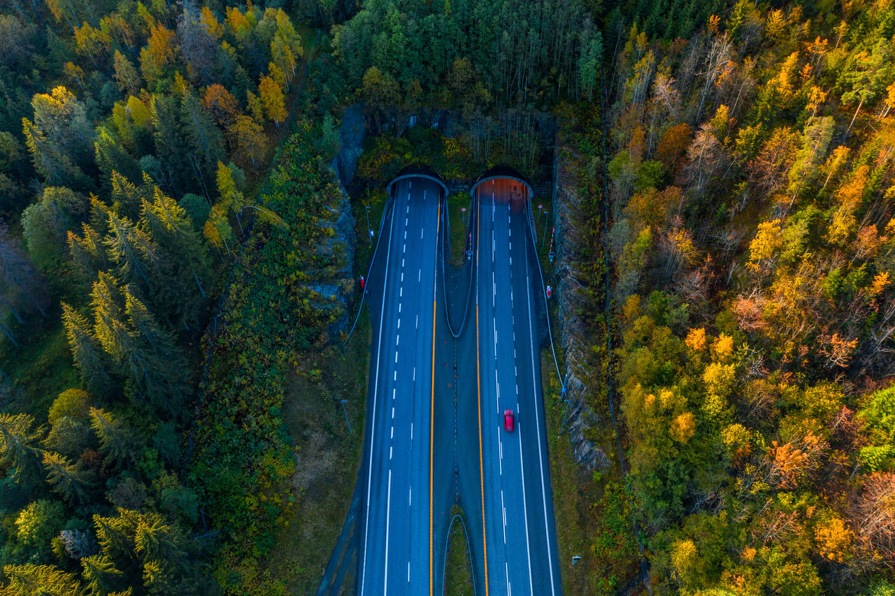 Aerial view of car entering highway tunnel